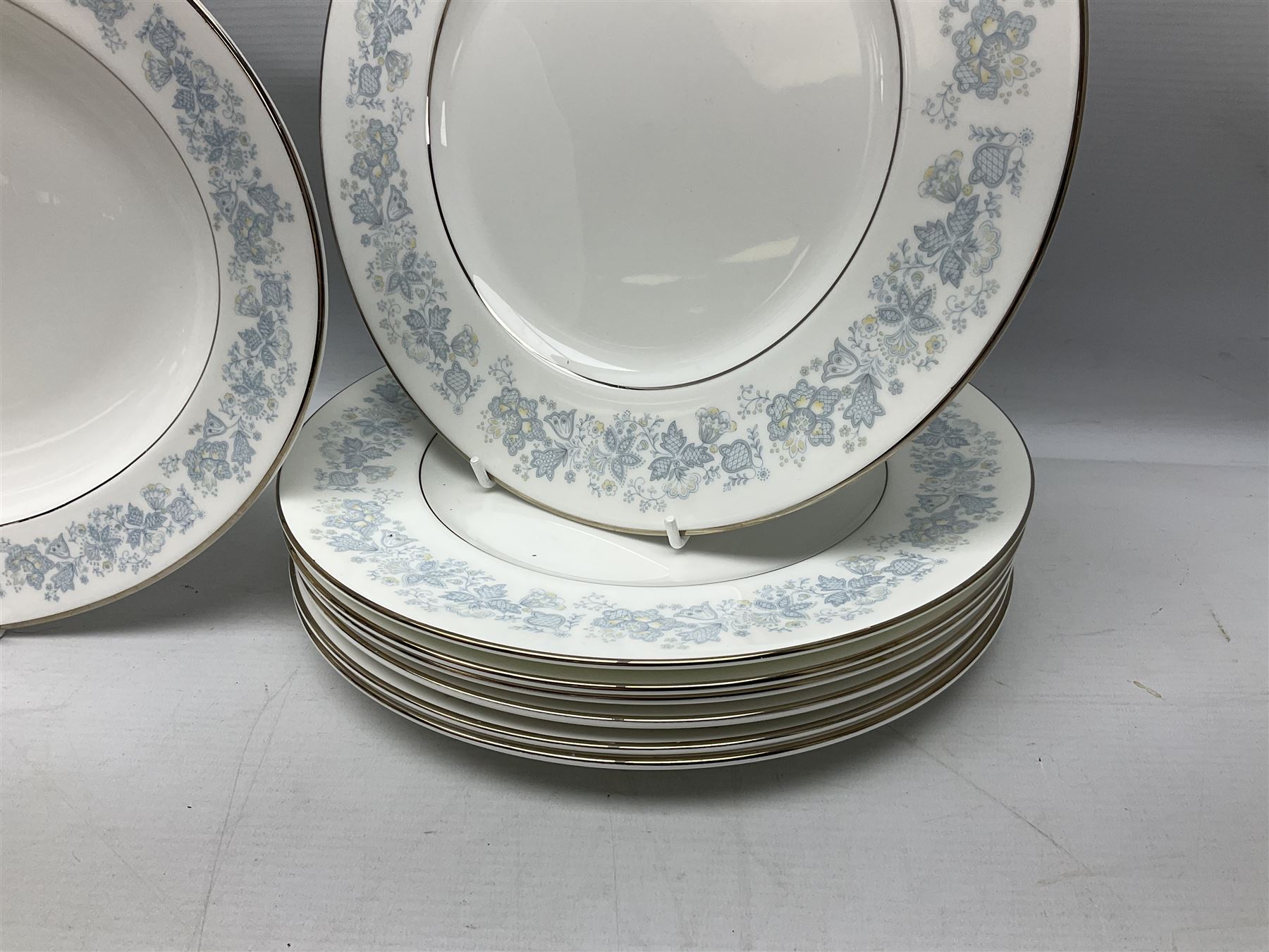Royal Doulton tea and dinner wares in the Meadow Mist pattern, no H5007, comprising seven dinner plates, eight side plates, two lidded tureens, two jugs, lidded sucrier, oval serving dish, six teacups, seven saucers, seven tea plates and large saucer