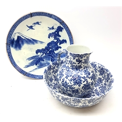  Early 20th century Japanese blue and white charger decorated with cranes in a mountainous landscape D45cm and a Cauldon Blue May pattern jug and bowl set   