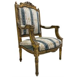 Late 20th century French design carved giltwood armchair, the cresting rail carved with scrolled foliage over foliate carved platform, upholstered in striped fabric decorated with trailing foliage and flower heads, acanthus carved arm terminals and upright supports, on turned and fluted supports 