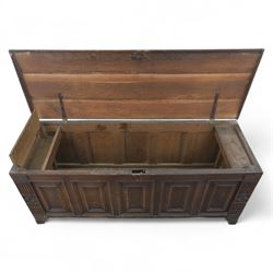 18th century oak five panel chest, with planked top with chamfered edges, hinged top enclosing two candle boxes, five fielded panels flanked by foliate carvings, raised on stile supports