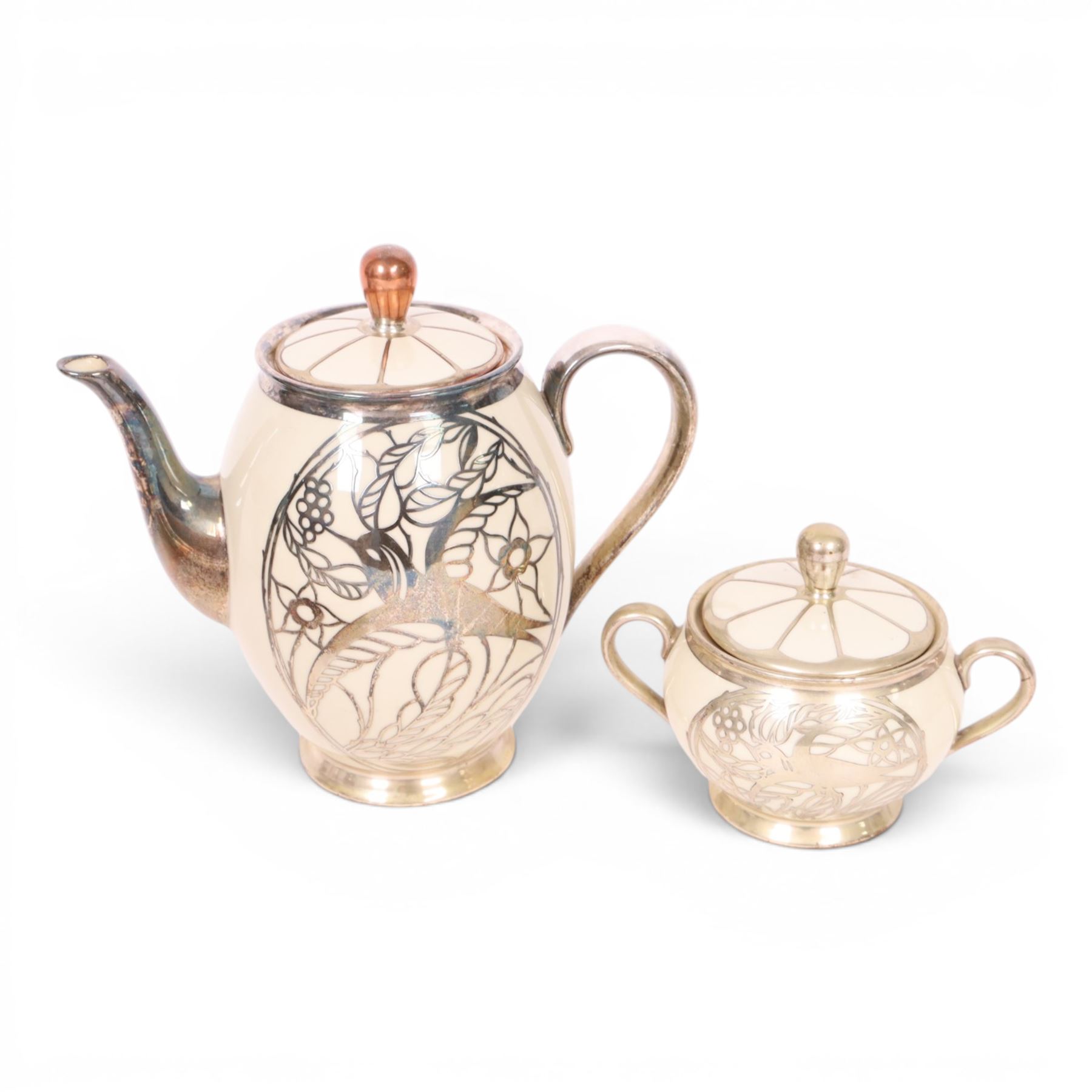 Jacob Hertel Bavarian tea service, decorated with silvered overlay of birds in foliage, comprising teapot, milk jug, covered sucrier three cups and saucers 