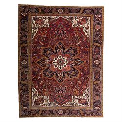 North West Persian Ahar hand-knotted carpet, madder red ground, with a large central shape...