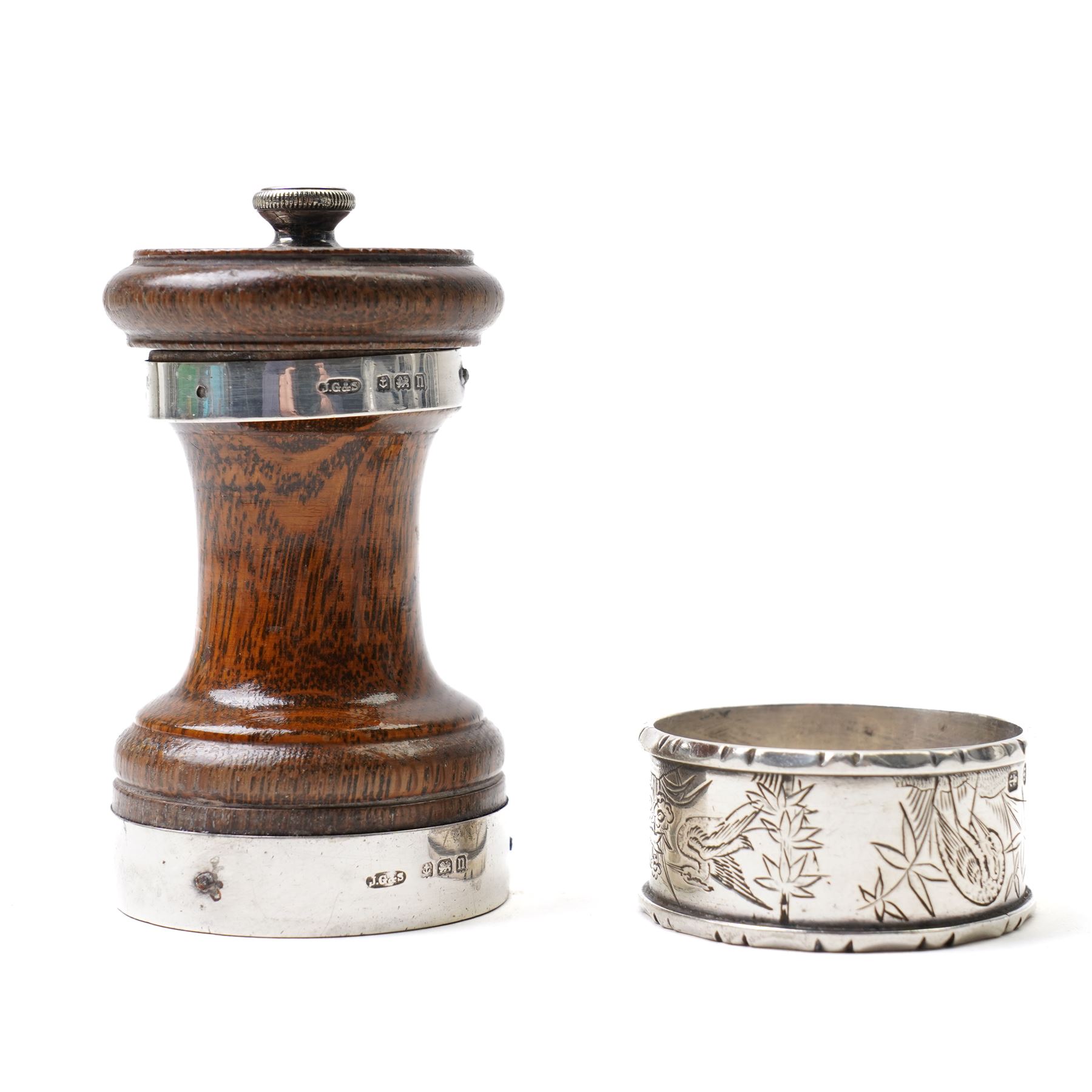 Silver napkin ring with engraved decoration and silver mounted oak pepper mill