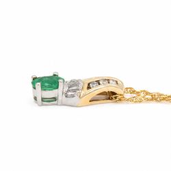 14ct white and yellow gold emerald and diamond pendant necklace, five tapered baguette cut diamonds and six round cut diamonds, suspending a single oval cut emerald of approx 0.45 carat, on a Singapore link chain necklace