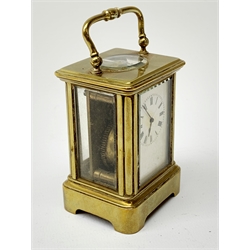 A brass cased miniature carriage clock, the white enamel dial with black Roman numerals, H7cm. 
