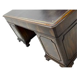 Large Georgian design mahogany twin pedestal partner's desk, moulded rectangular top with canted corners and inset leather writing surface, fitted with nine drawers and two cupboards, the pedestals with canted uprights decorated with blind fretwork, on ogee bracket feet