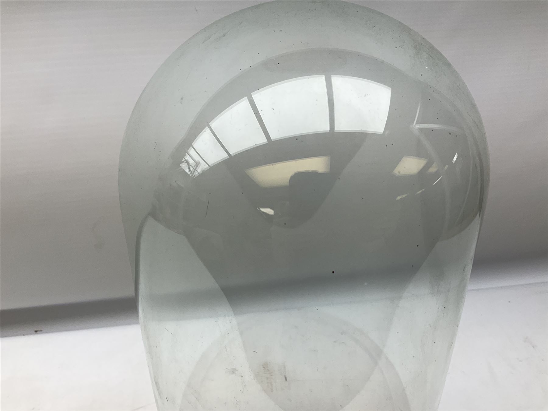 Glass dome display covers on a circular wooden base, H46cm