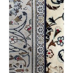 Persian Kashan rug, ivory ground with trailing and interlacing foliate design and decorated with stylised flower heads, repeating guarded border with scrolling decoration 