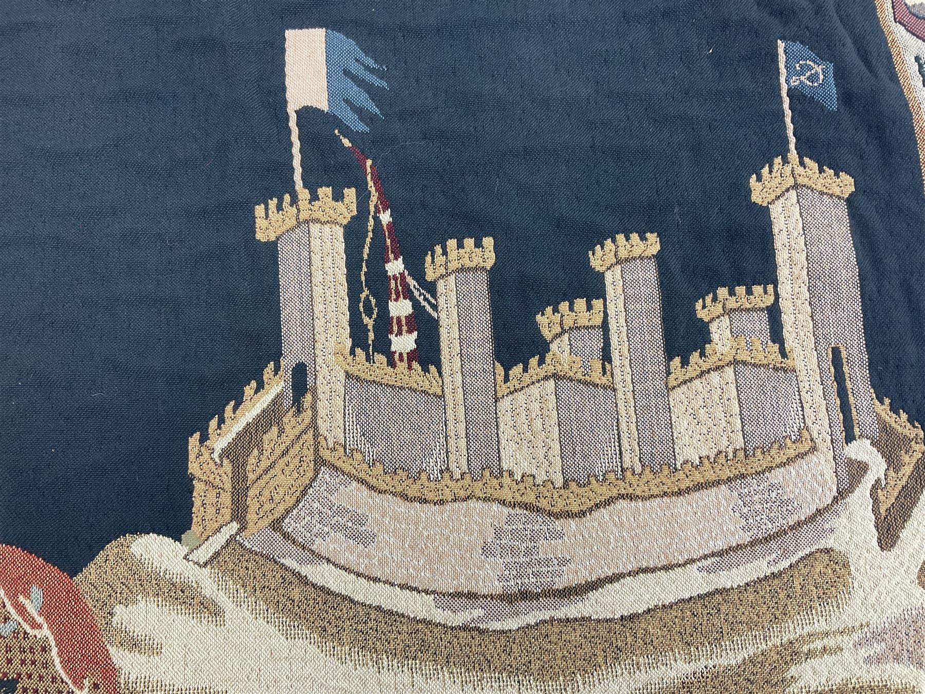 Three tapestries comprising 20th century wool tapestry panel of a medieval nobleman upon a horse with a castle in the distance, together with a smaller tapestry depicting The English Coat of Arms, both hung on rails, and further depicting village scene, largest approx 132cm x 95cm