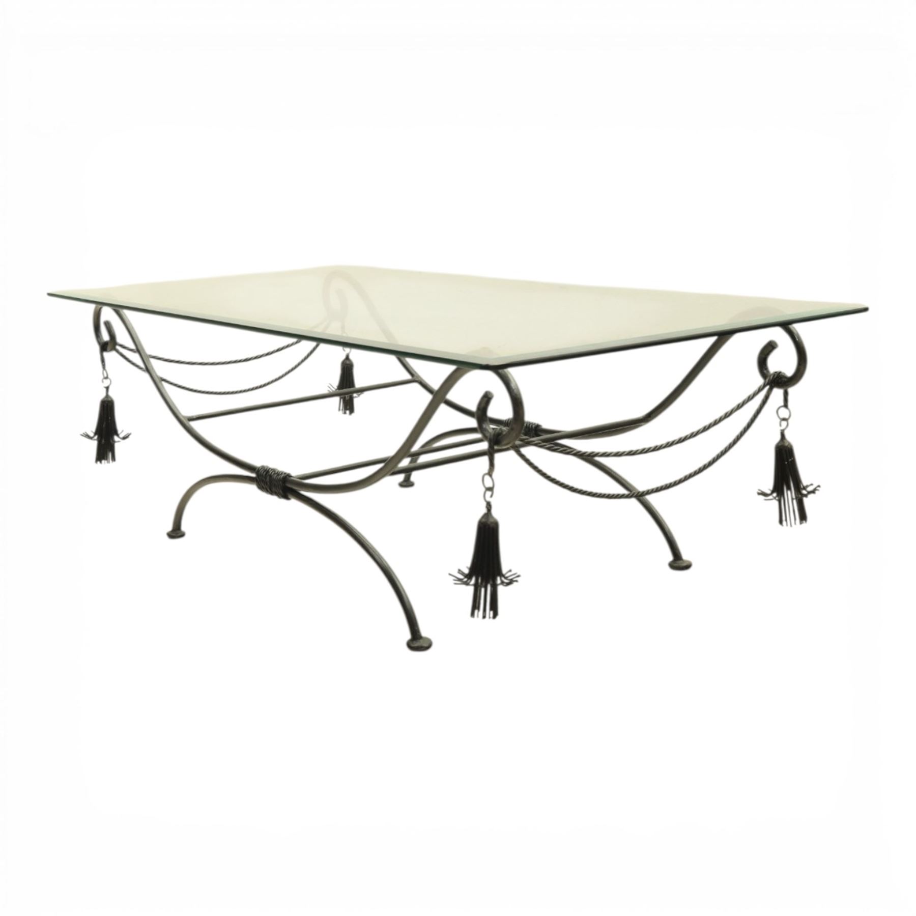 In the manner of Maison Jansen - Regency inspired glass and wrought metal coffee table with scrolling X-form base