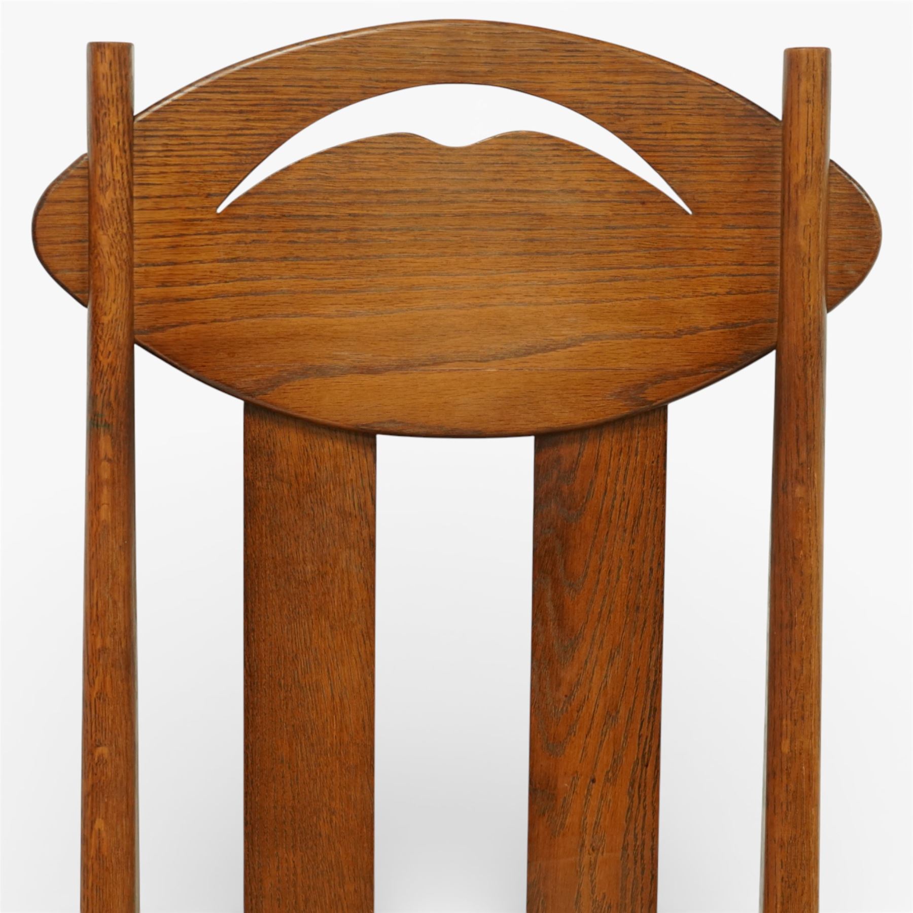Late 20th century Mackintosh design oak 'Argyle' dining chairs, with elongated backs featuring pierced shaped top rails and twin vertical splats, upholstered seats, raised on square legs with stretchers