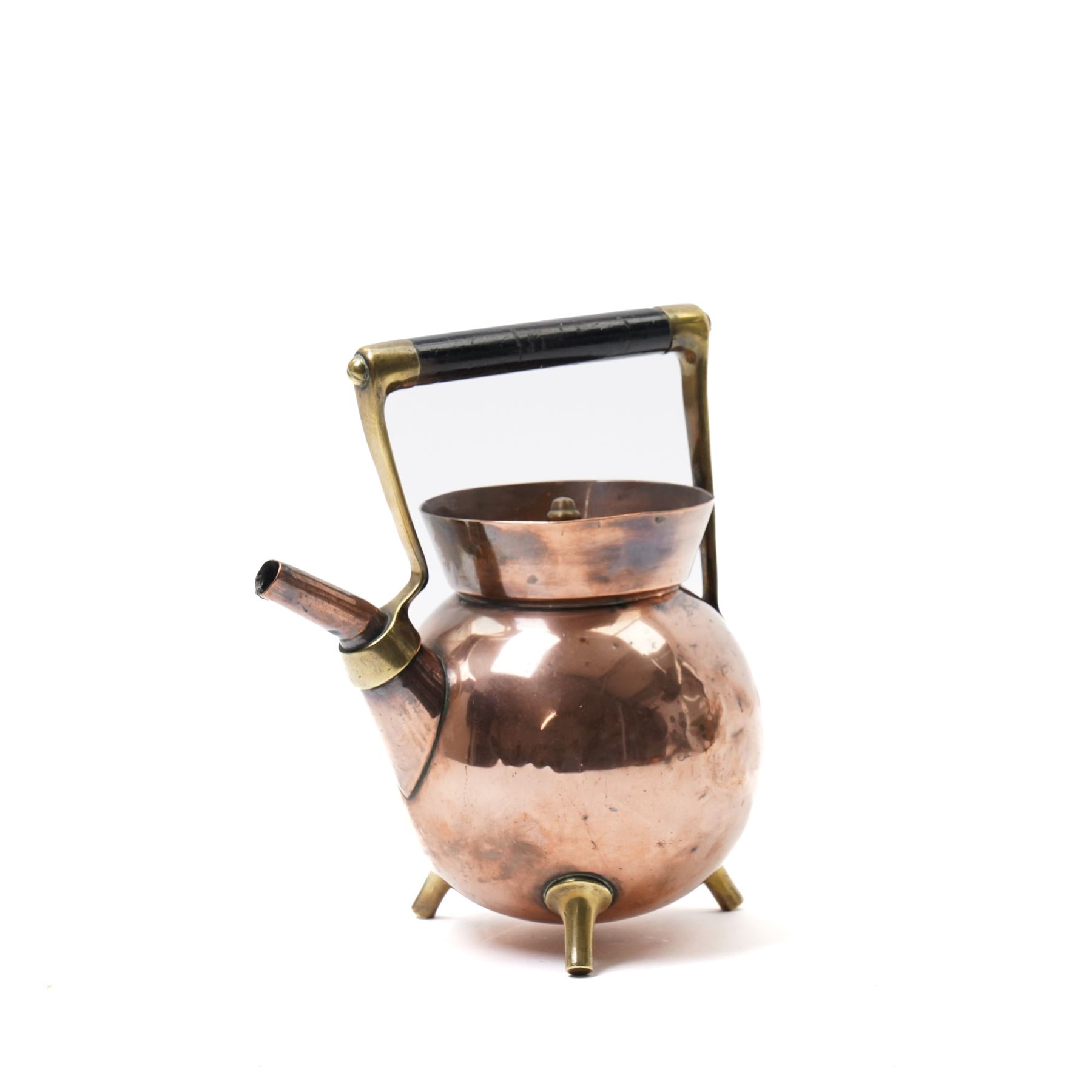 Copper teapot designed by Dr Christopher Dresser for Benham & Froud of bulbous form with brass and wood handle and three spur feet, impressed mark H24cm 