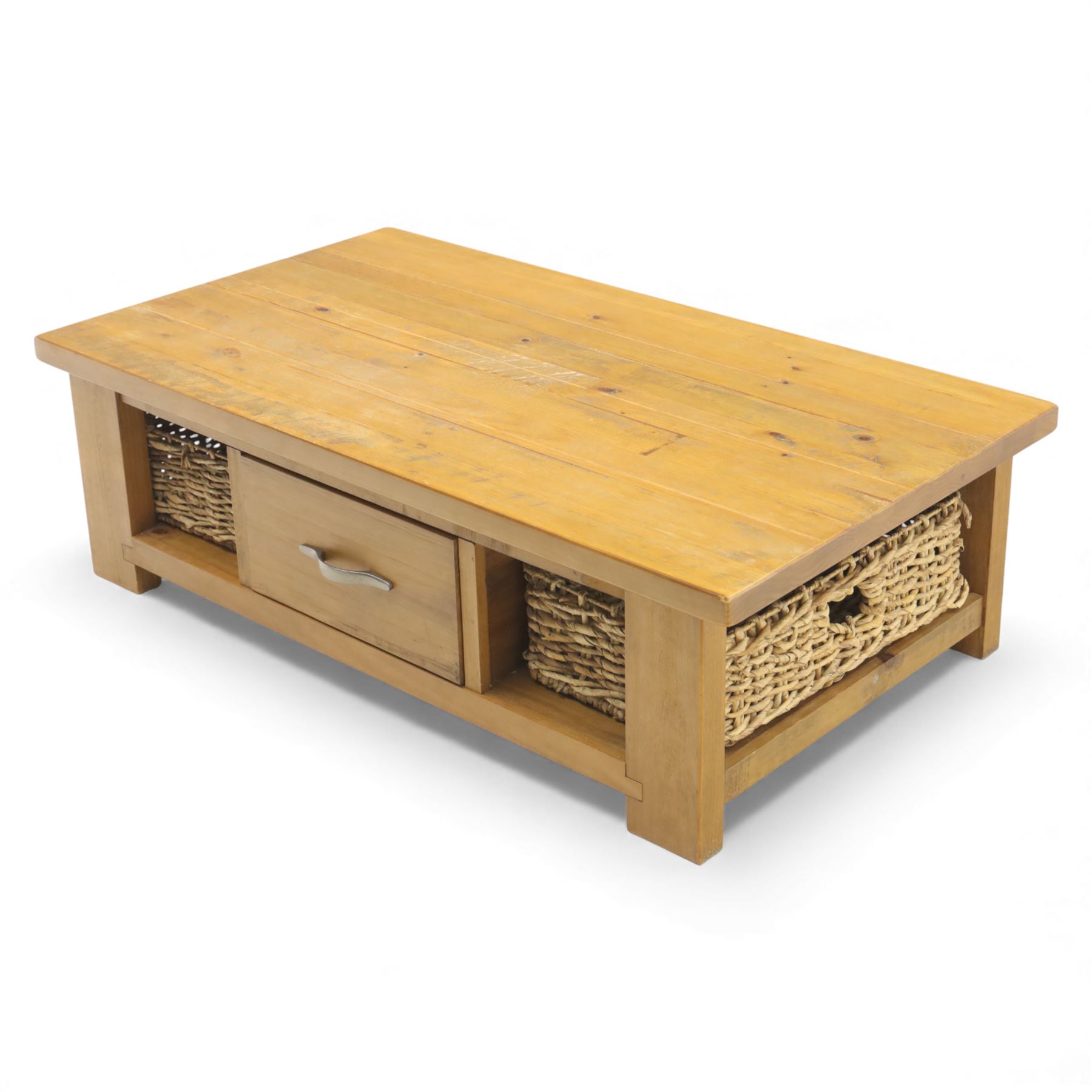 Contemporary pine coffee table, rectangular planked top with moulded edge, fitted with a central drawer to either side with brushed metal handle, flanked by two open compartments housing wicker basket drawers, plain sides, raised on square block feet