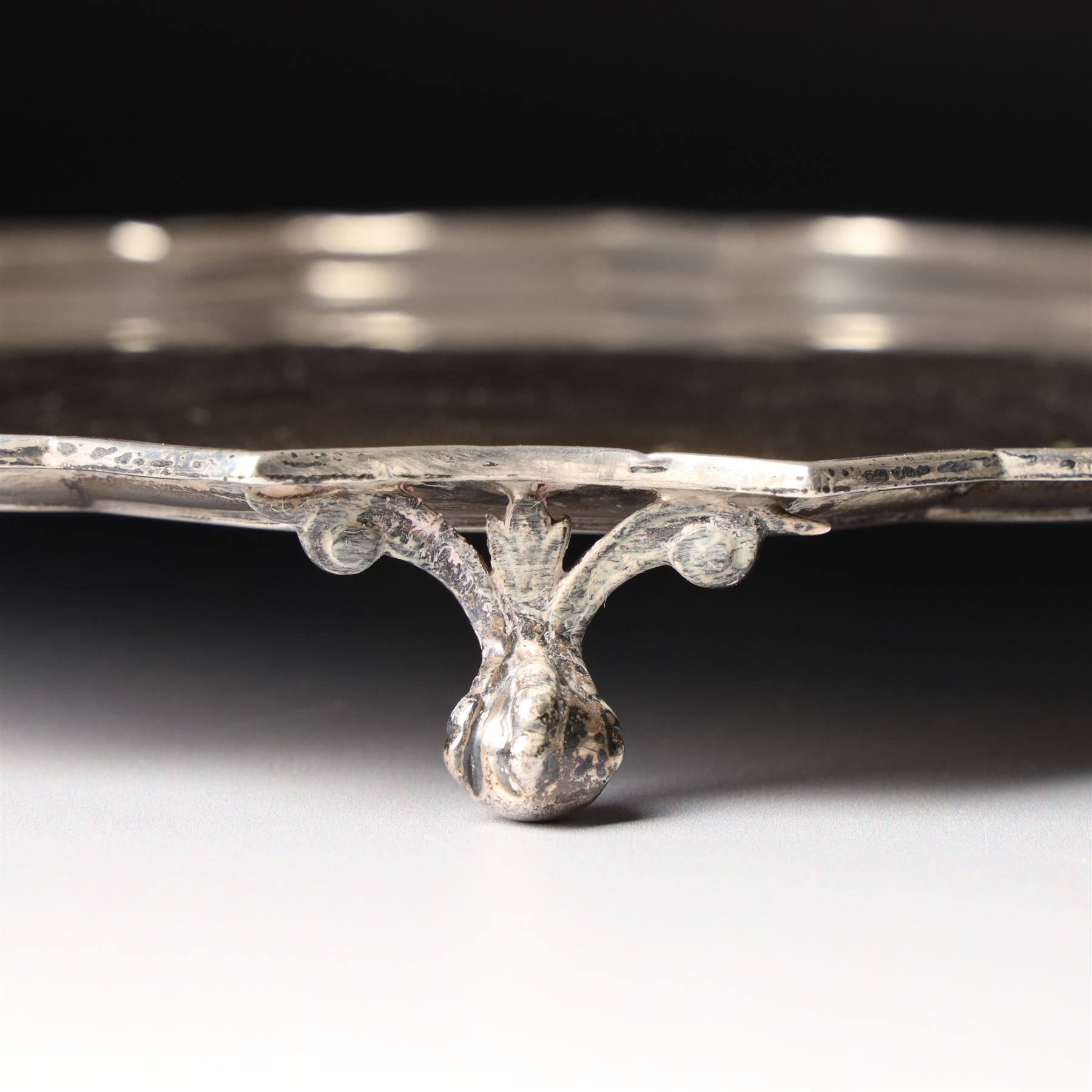 Square silver salver with canted corners and raised border on claw and ball feet 25cm London 1934 Maker Searle & Co Ltd
