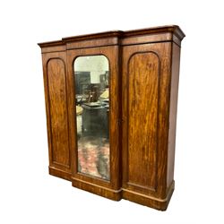Victorian mahogany break front triple wardrobe, projecting moulded cornice over central mirror glazed door and two panelled doors, fitted with linen slides and three drawers, on plinth base