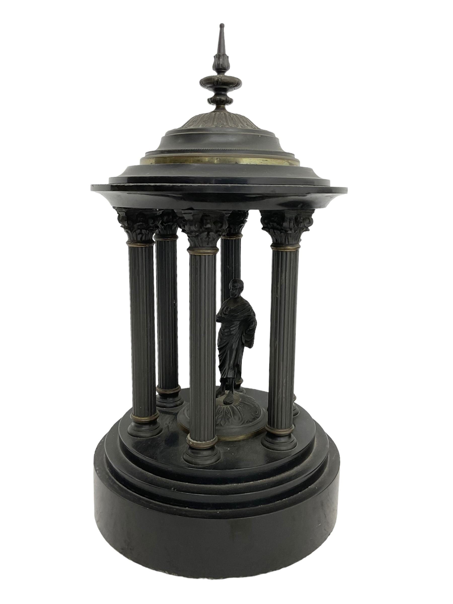 French- Black Belgium slate 8-day Victorian mantel clock  and garnitures with with malachite inlay, drum cased movement with volutes curved supports to the sides, two-part enamel dial with Roman numerals, moon hands and a visible Brocot escapement, striking movement, striking the hours and half-hours on a bell, with matching portico garni in the form of a Roman temple. With pendulum.