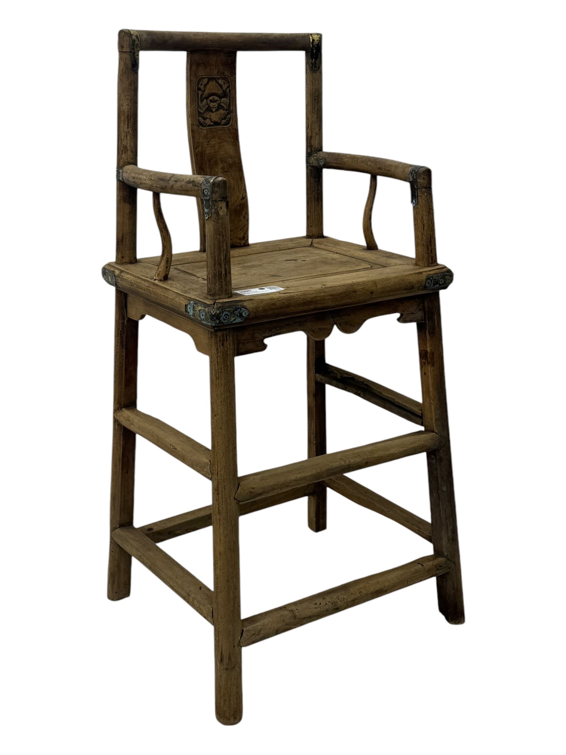 Late 19th century Chinese Qing dynasty high chair, rectangular back with central splat carved with stylised bat motif, applied brasswork to the arms and seat, on rounded supports with double stretcher