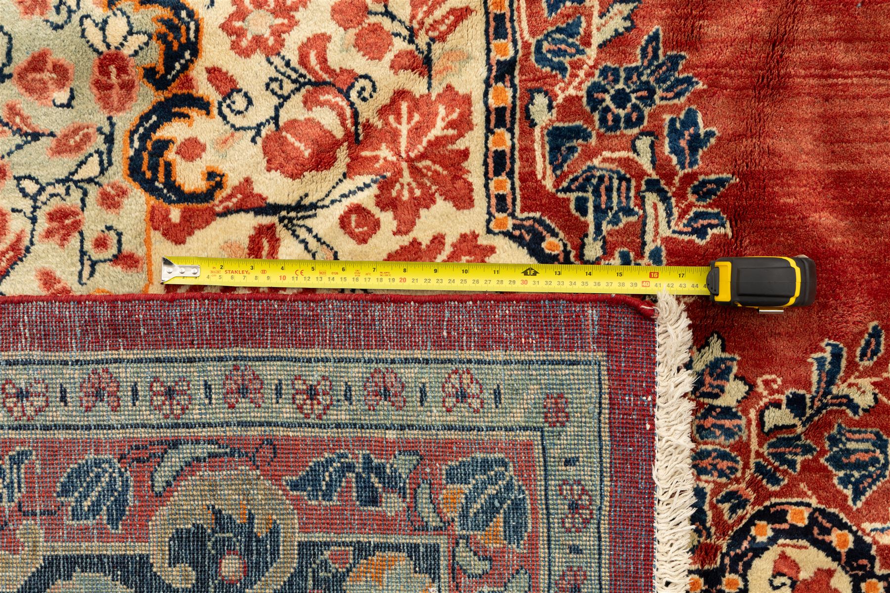 West-Central Persian Mahal hand-knotted carpet, terracotta field with a large central indigo and ivory medallion with floral palmettes and scrolling vines, framed by ivory spandrels with dense foliage within a broad navy border of lotus and palmette motifs linked by scrolling tendrils and multiple guard stripes 