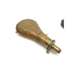 Victorian large copper powder flask embossed with a hunting scene within an oak leaf border with stag and fox heads, the nozzle marked 'Extra Quality Sykes Patent', fitted with four suspension rings H24cm; together with Victorian leather shoulder shot flask with Sykes nozzle L80cm (2)