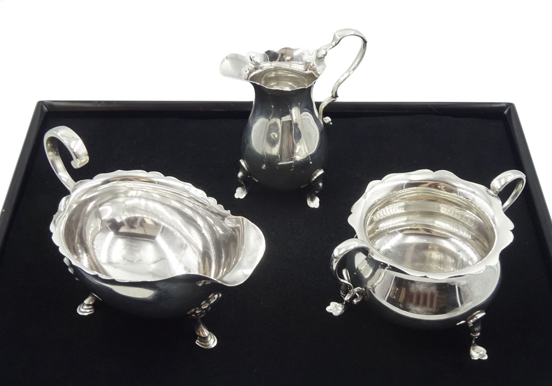 Silver milk jug and sugar bowl by Robert Pringle & Sons, London 1919 and a silver sauce boat by Sheffield Harrison Brothers & Howson, Sheffield 1904, approx 7.7oz