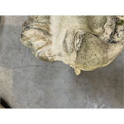 Four grotesque garden wall masks