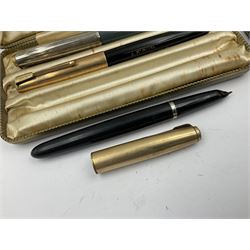 Three parker fountain pens, one example with 14ct gold plated cap and personal engraving, in Parker 51 box, together with a silver Sampson Mordan Everpoint propelling pencil with personal engraving and a silver cased fountain pen with 14ct gold nib and a souvenir bronze Dollfus-Mieg medallion, awarded to John G Sedorski, in fitted case 