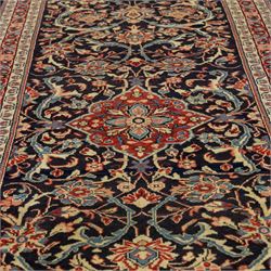 North West Persian Hamadan hand-knotted runner, deep navy field with central stylized medallion with pendants, surrounded by angular floral motifs, within an ivory border of repeating rosettes and stylized leaves, enclosed by guard stripes, fringe ends 