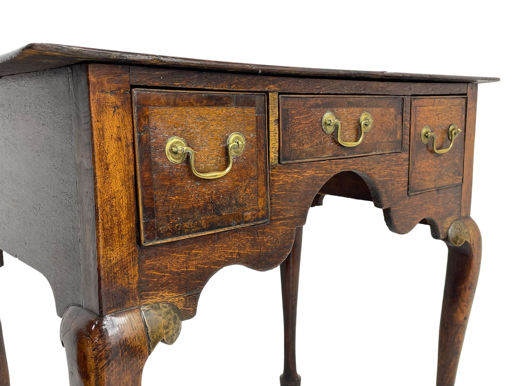 18th century oak low-boy, rectangular top over three crossbanded and cock-beaded drawers, ogee and stepped arch apron, on cabriole supports 
