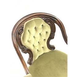 Victorian rosewood open armchair, shaped and moulded down swept frame, the back carved with a series of c-scrolls, scrolled and floral carved arm supports and cabriole feet with scroll carved terminals, upholstered in deep green buttoned fabric, brass castors
