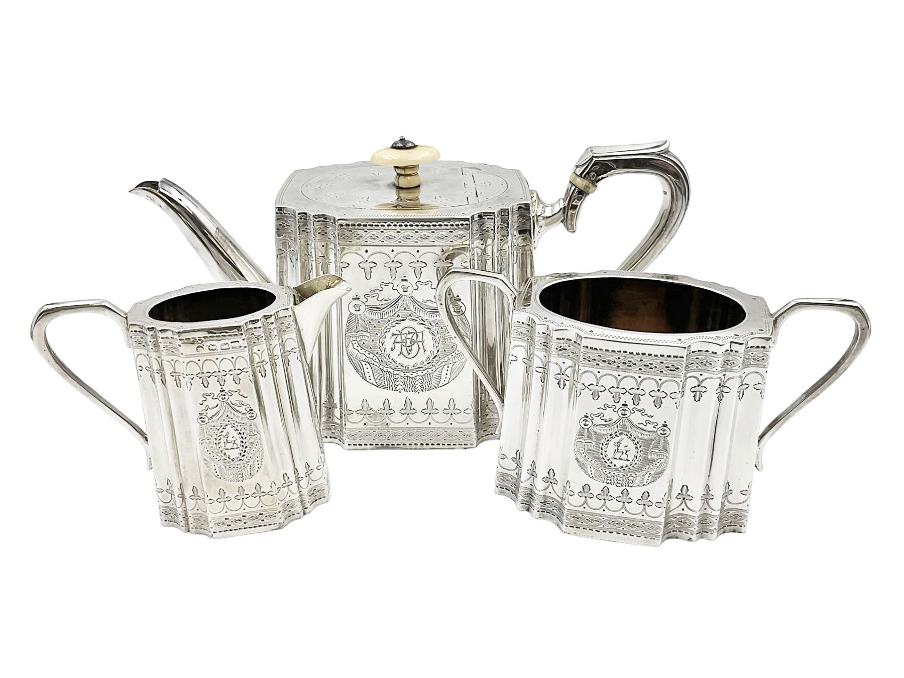 Victorian three-piece silver tea service, comprising teapot, twin handled open sucrier and milk jug, of oval form with shaped rim and C handles, each engraved with crests and bands of strapwork decoration, the milk jug and sucrier with gilt interiors, hallmarked Josiah Williams & Co, Exeter 1881, the teapot with ivory insulators and finial, all contained with a tooled leather, blue silk and velvet lined fitted case, retailed by West & Sun, Dublin 
This item has been registered for sale under Section 10 of the APHA Ivory Act