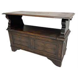 17th century design stained oak monks bench, hinged metaphoric table back, over hinged box seat compartment, the panelled front carved with foliate decoration and lozenges