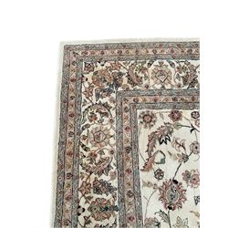 Persian design ivory ground rug, decorated all-over with interlacing foliate, plant and flower head motifs, repeating and scrolling border with guards