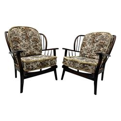 Joynson Holland - pair of mid-20th century stained beech framed easy chairs, shaped back and flat armrests over floral tapestry cushioned seat and back, on splayed supports united by stretcher