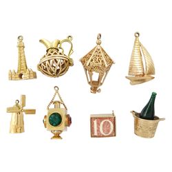 Seven 9ct gold pendant / charms including champagne bottle Blackpool Tower, sailing boat, money box, lantern and jug, all hallmarked and a 14ct gold windmill charm
