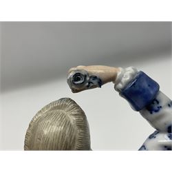 Meissen blue and white figure, modelled as a gentleman holding a hat of flowers, raised upon Greek key design base, with blue crossed swords and impressed C 73 and 149 marks beneath, H18cm