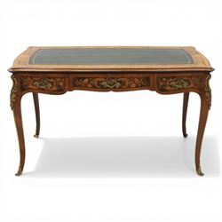 Late 19th century French kingwood and marquetry bureau plat, the serpentine rectangular top with green leather inset writing surface within crossbanded and foliate marquetry border, above a shaped frieze fitted with three drawers with floral marquetry panels and gilt metal handles, upon cabriole supports with applied gilt metal mounts and sabots