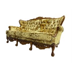Large French design stained beech three seat settee, carved and pierced cresting rail with cartouche and scrolling foliate decoration, scrolled arms, upholstered in crushed gold velvet, the apron heavily carved with floral cartouche motifs, raised on ball and claw feet