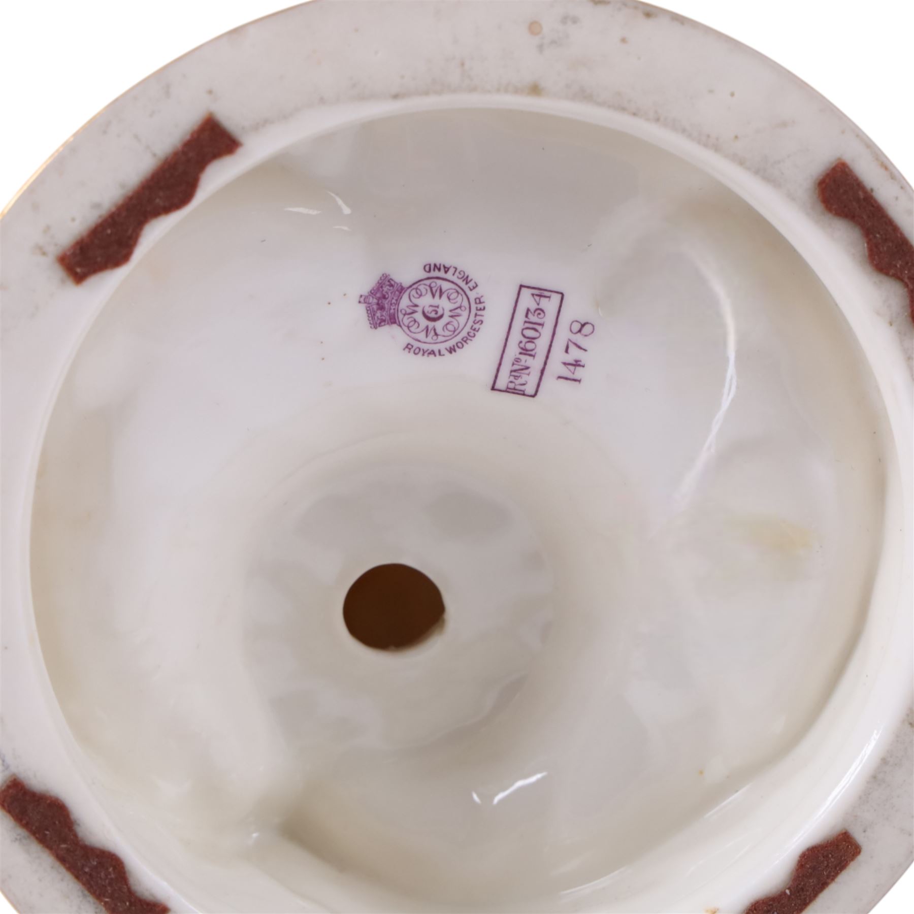 Royal Worcester pair of blush ivory candlesticks, modelled in the rococo style of scrolling foliate design upon a circular spreading base, gilt-heightened, puce mark to base and numbered RN160134 and 1478, H32cm