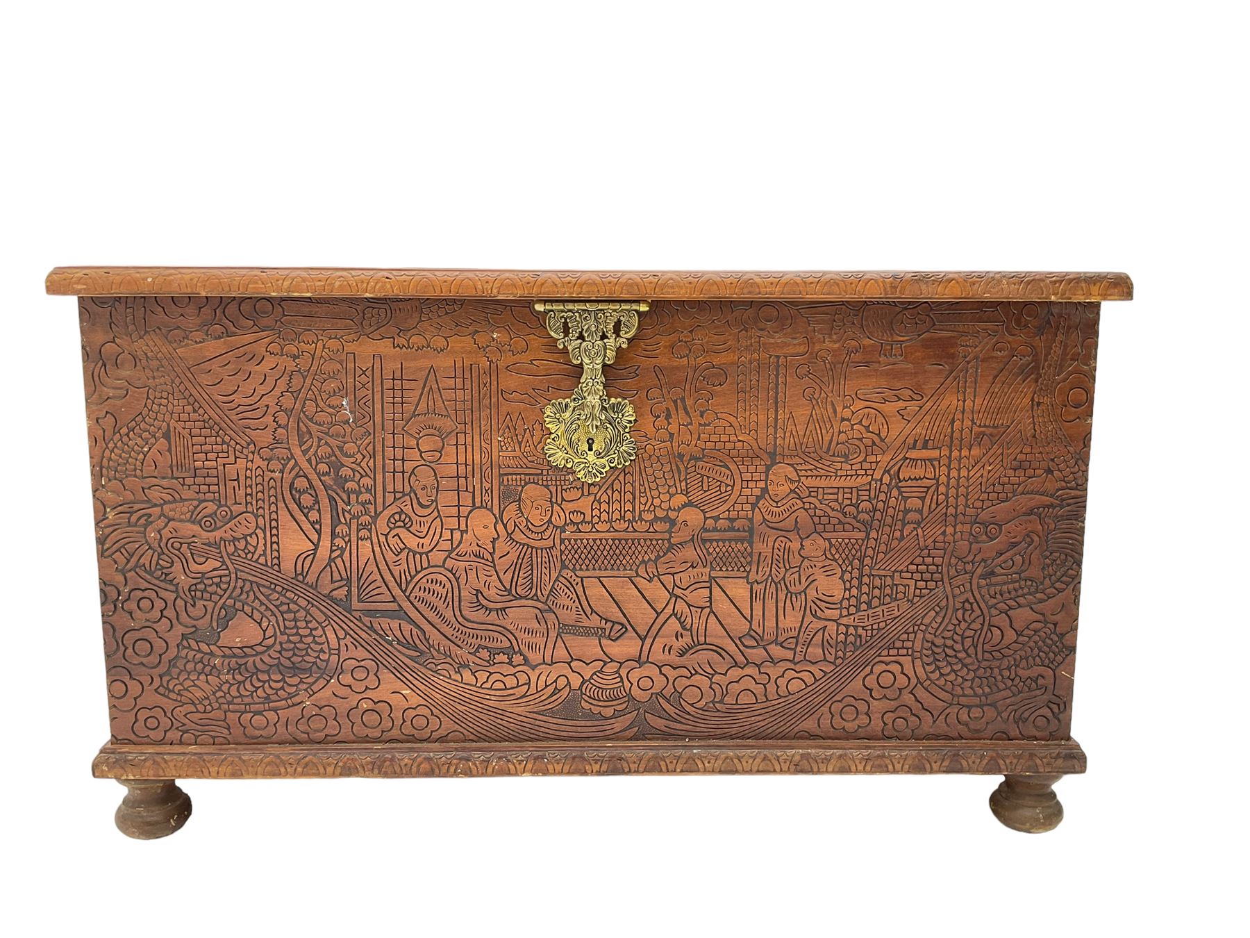 Hong Kong camphor wood chest, rectangular hinged top, carved all over with traditional scenes and dragon boats, on bun feet