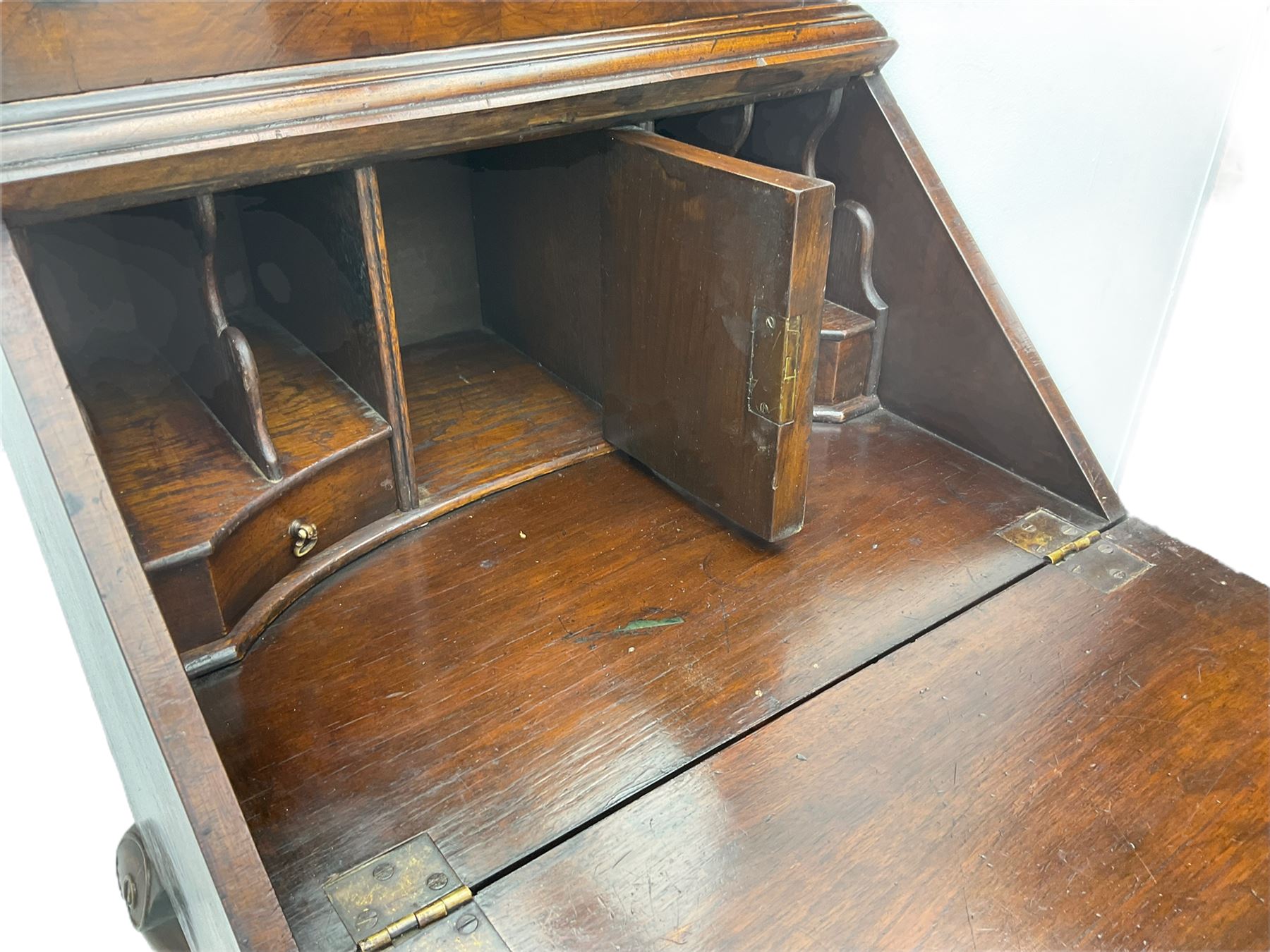 Small early 20th century Queen Anne style bookcase on bureau secretaire, the moulded arched pediment over mirrored door in shaped frame, the bureau fitted with fall front enclosing curved fitted interior, cushion moulded drawer over single drawer, on scroll and shell carved cabriole supports