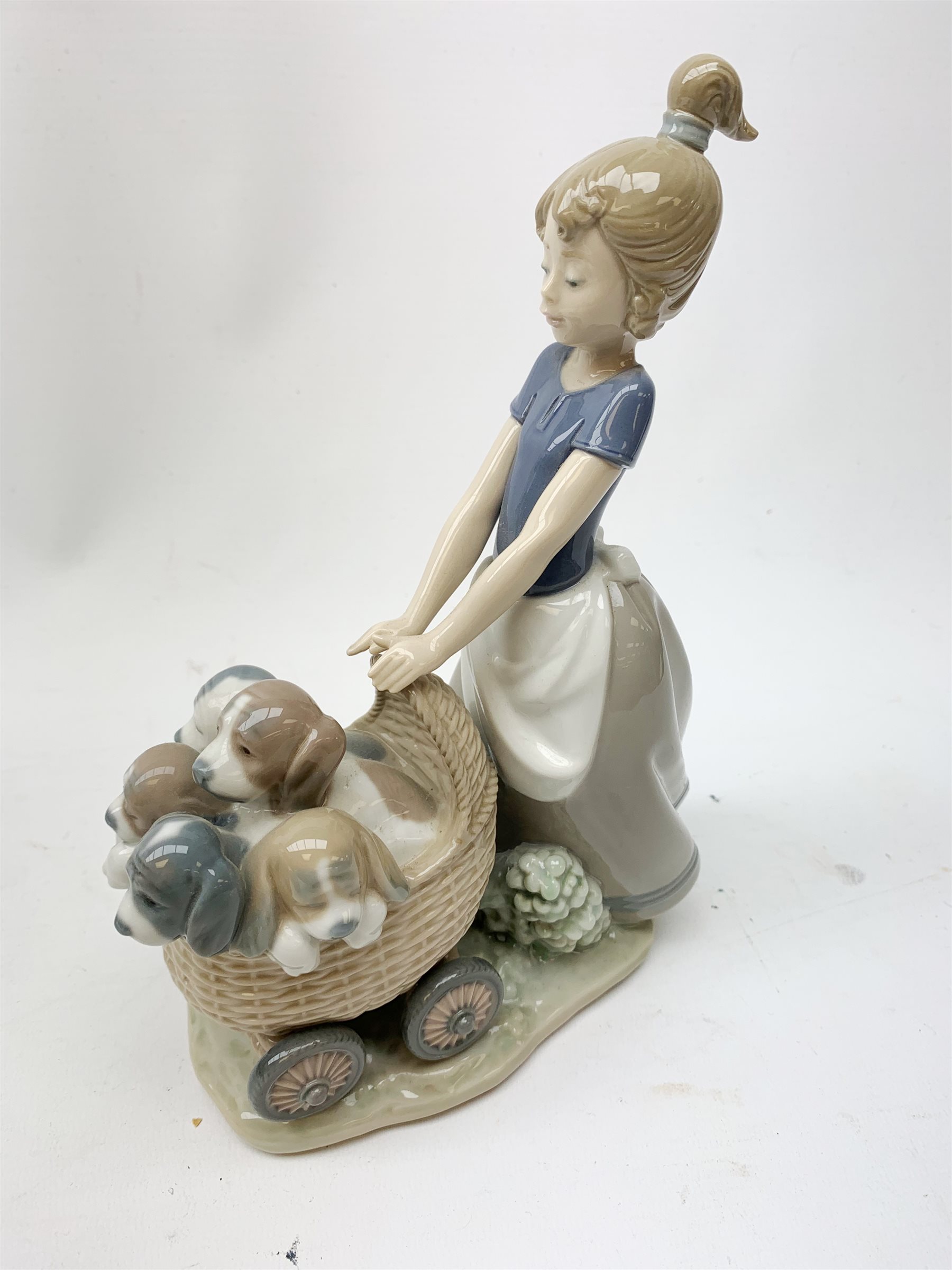 A Lladro figurine, 'Barrow of Fun' Model 5460, H20.5cm, together two further Lladro figurines, 'Litter of Fun' Model 5364, and 'It wasn't me' Model 7672. 