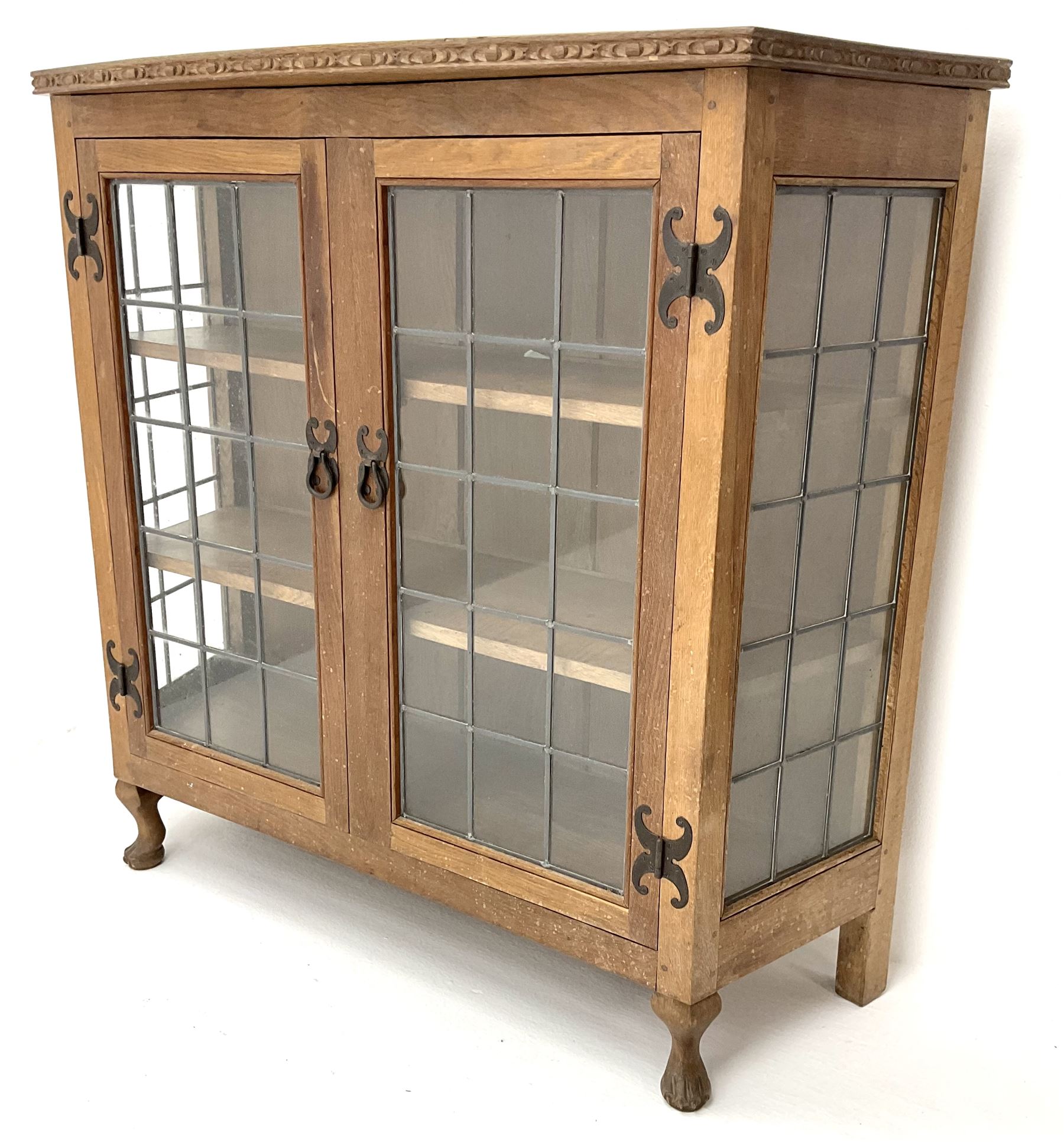 David 'Oakleaf man' Langstaff of Easingwold Yorkshire oak cabinet, egg and dart detailing, with two lead glazed doors enclosing two shelves, bearing oak leaf signature, cabriole claw feet