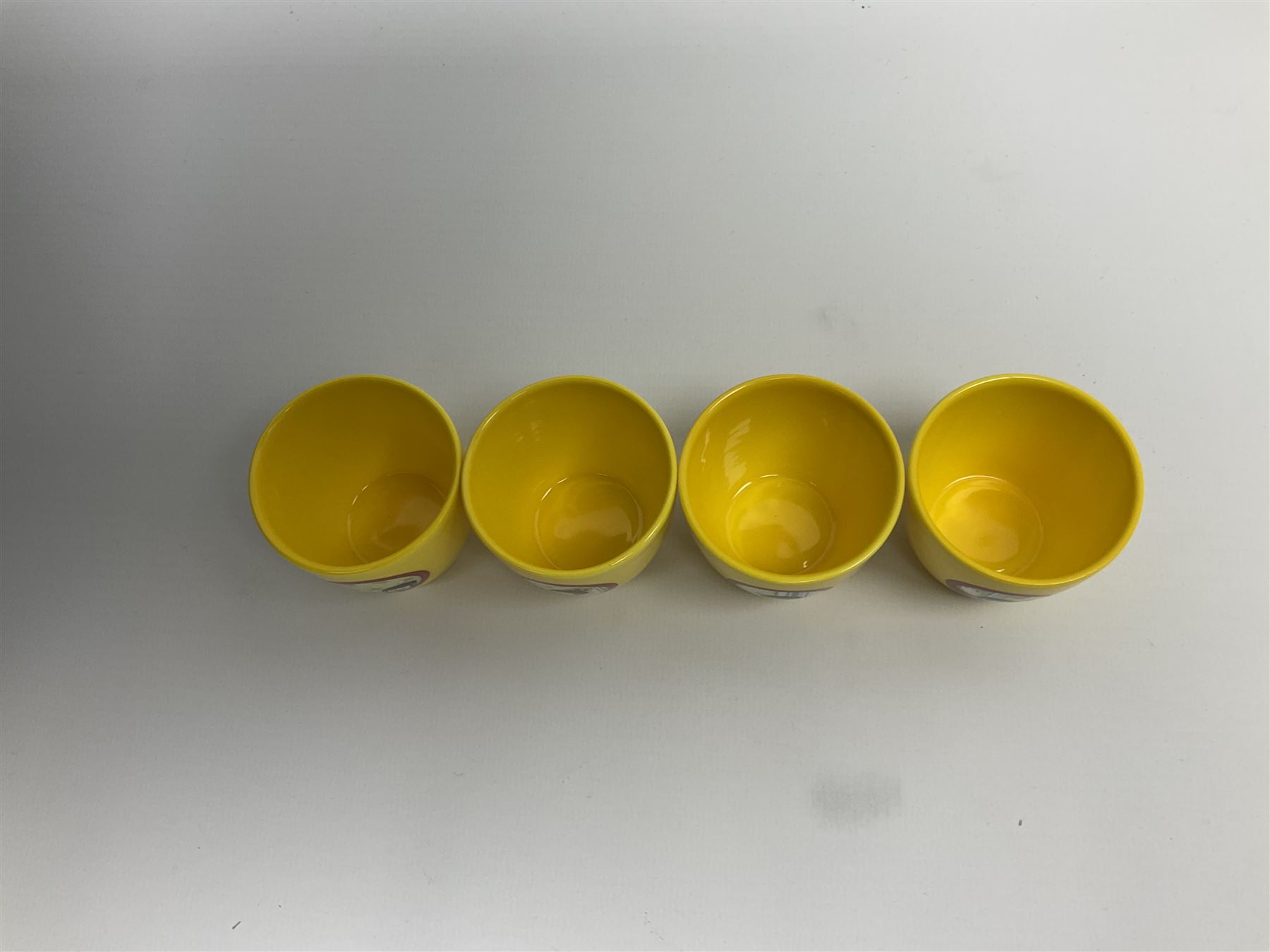 Limited edition Beatles Yellow Submarine teapot, designed by Paul Smith and made for Thomas Goode, 4/200, together with matching egg cups, 25/200, both in original boxes. 