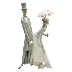 Lladro figure, Couple with Parasol, modelled as a courting couple in Edwardian style dress with a puppy, sculpted by Fulgencio Garcia, with original box, no 4563, year issued 1969, year retired 1985, H50cm