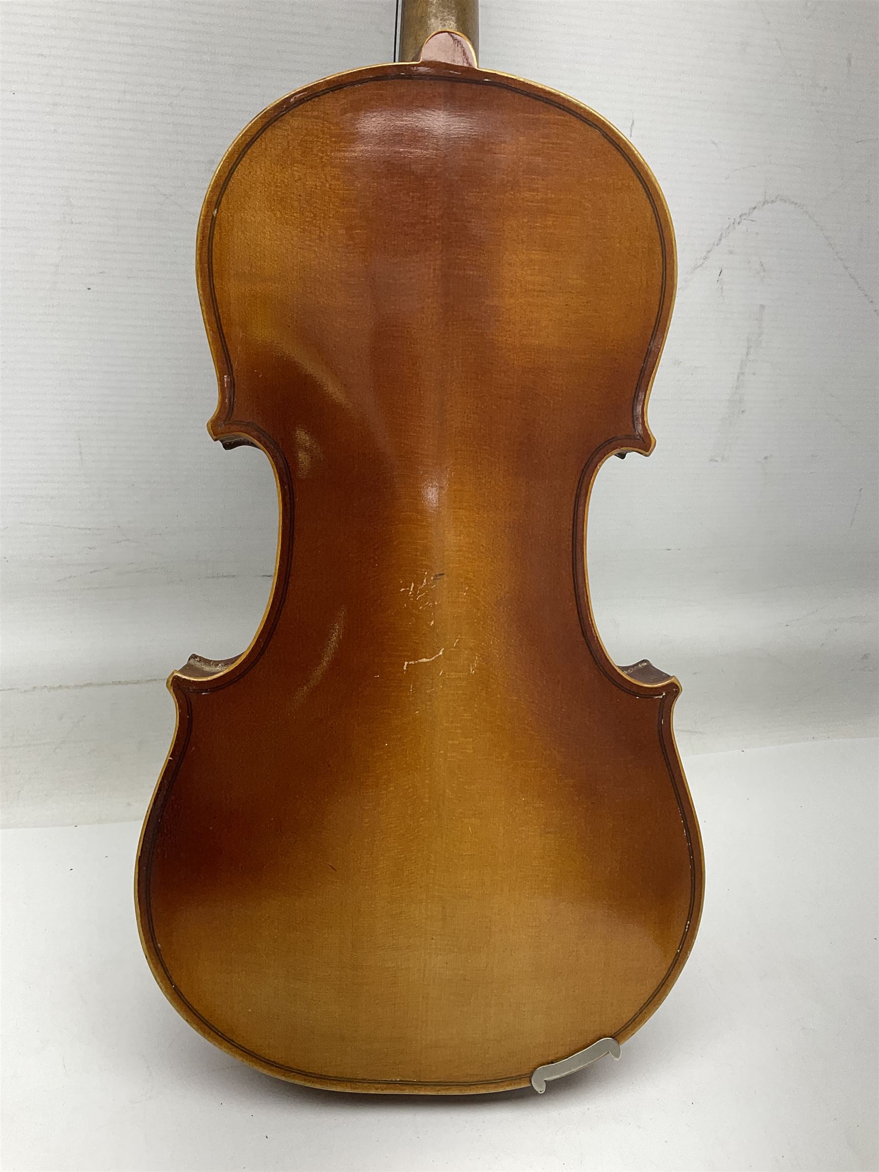 Czechoslovakian violin c1920 with 36cm two-piece maple back and ribs and spruce top, bears label 'Copy of Antonius Stradivarius Made in Czechoslovakia' L59cm; in carrying case; 1950s Czechoslovakian violin; and 195os Czechoslovakian three-quarter size violin; both cased (3)