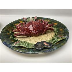 Two 20th Century Portuguese Palissy style Majolica wall plates, one depicting a crab, the other a lobster each to the centre modelled in relief surrounded by encrustations and shells, both with impress marks beneath, D32cm