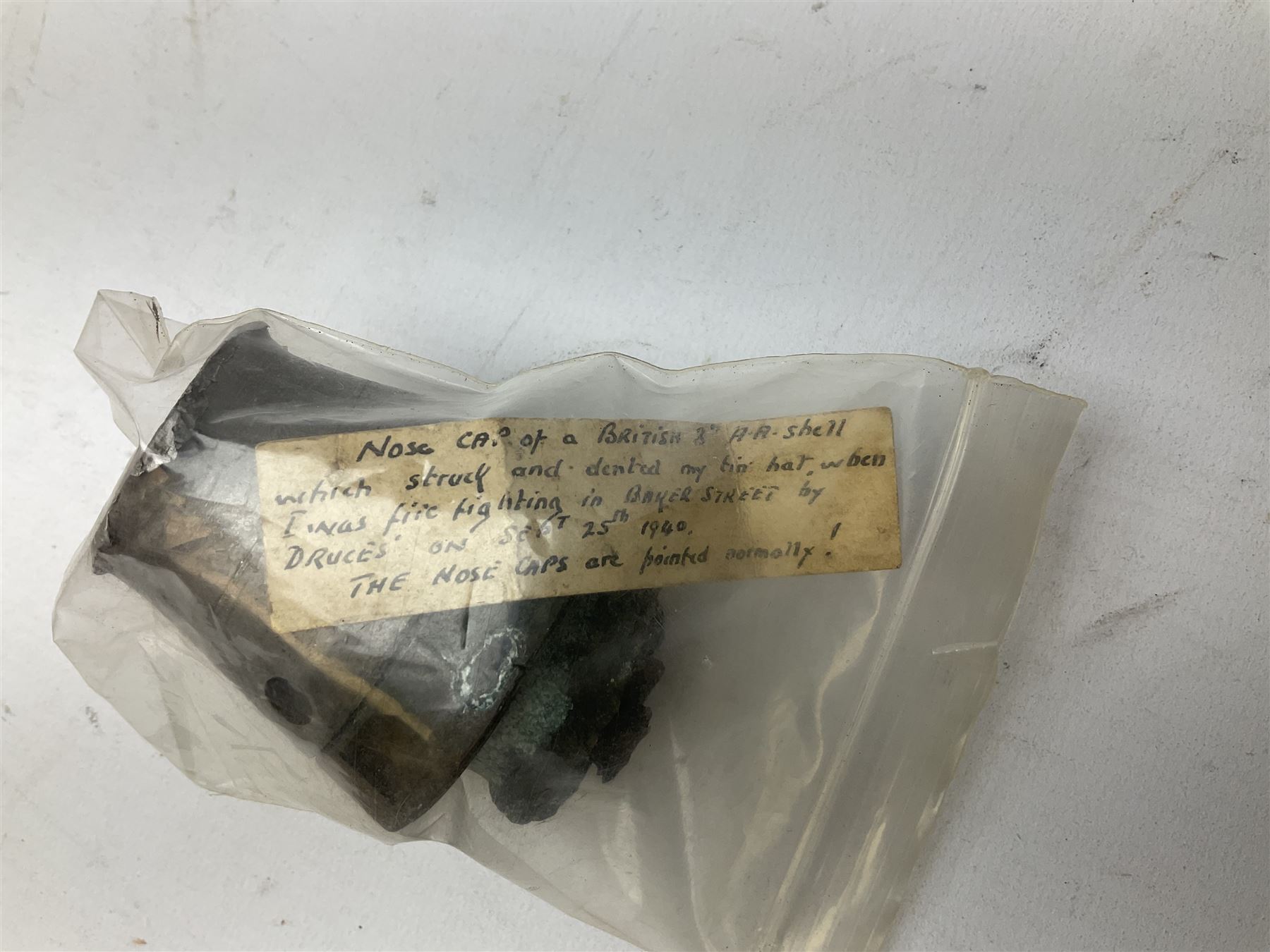 Small collection of WW2 shrapnel and German and British shell parts, most with manuscript details of where and when found including London, Leeds, Bristol, Linton-on-Ouse etc