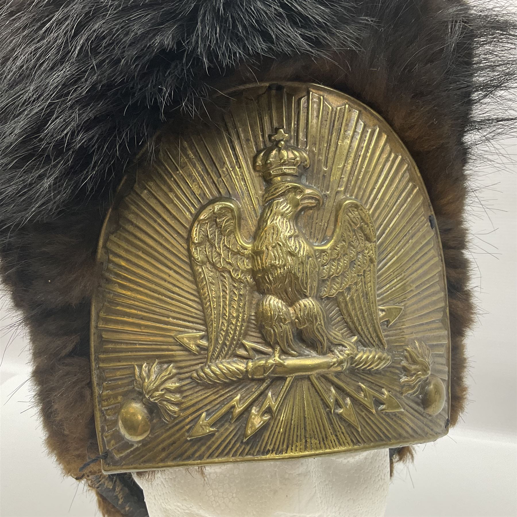 French Grenadier's bearskin hat, the embossed brass plate with crowned eagle, flaming grenades and arrow flashes; leather headband and traces of manuscript label internally