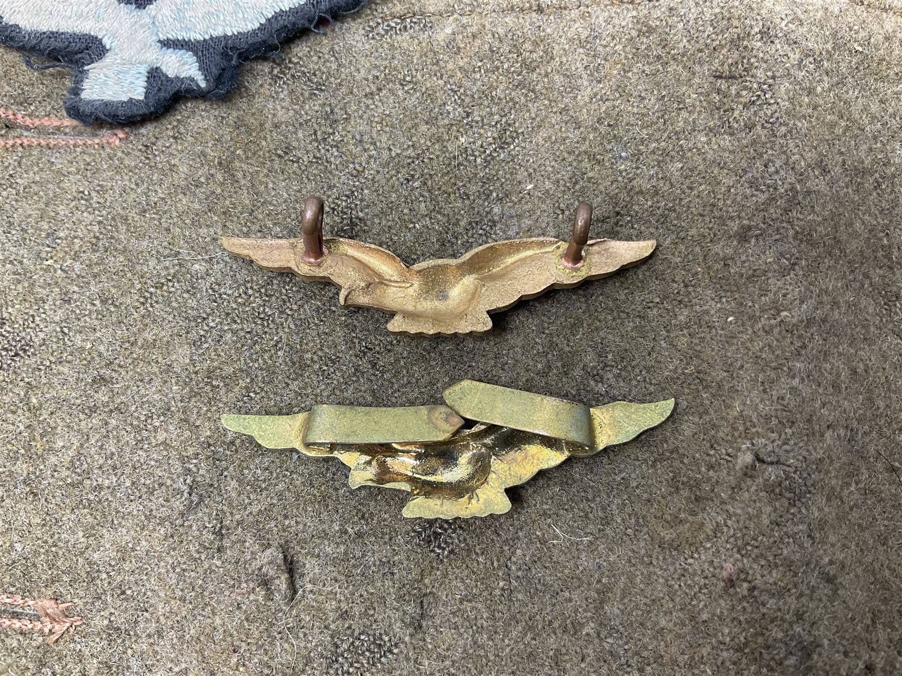 WW1 British Army Derby Scheme 1915 Attested armband; beret with East Yorkshire cap badge; pair of fur lined leather flying/motorcycle goggles; HMS Pembroke cap band; and small quantity of RNAS cloth and metal badges etc