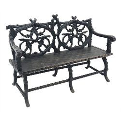  Victorian Black Forest carved bench seat, the branch work pierced back carved with oak leaves and acorns, solid seat with scroll arms and entwined border, S scroll feet joined by bobbin turned stretchers, W154cm, D63cm, H107cm  